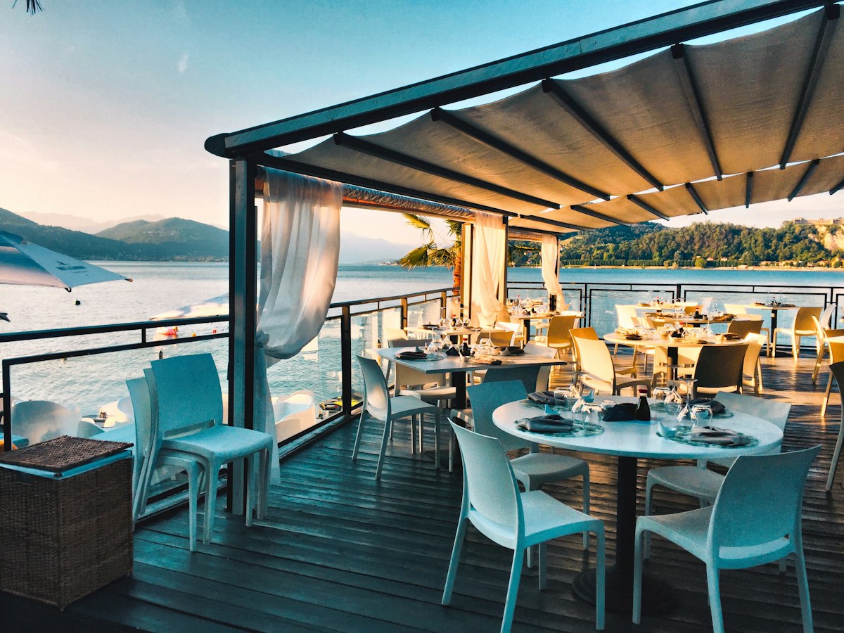 Restaurant dining area with tables beside large windows